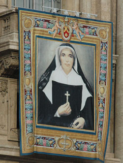 A banner of St. Theodora Guérin hangs from the facade at St. Peter’s Basilica on Oct. 15 for the liturgy during which Pope Benedict XVI declared her Indiana’s first saint. (Photo by Sean Gallagher) 