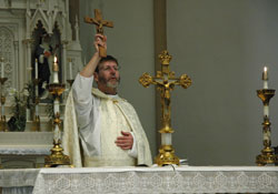 Jesuit Father Mitch Pacwa blesses the congregation during a celebration of the Maronite Rite Divine Liturgy on April 21 at St. Louis Church in Batesville.