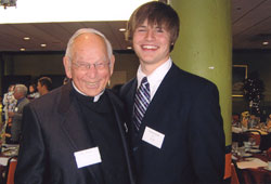 Father Donald Schmidlin shares a fun moment with his great-nephew, Jeremiah Gill, during the celebration of his 50 years as a priest on May 6 at St. Matthew Parish in Indianapolis. (Submitted photo) 