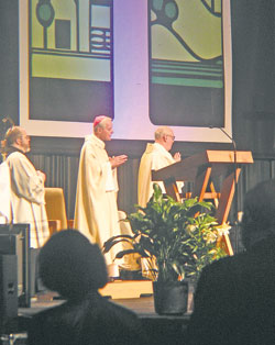 Benedictine Father Julian Peters, left, interim director of liturgy for the Archdiocese of Indianapolis and administrator pro-tem of SS. Peter and Paul Cathedral Parish in Indianapolis, Archbishop Donald W. Wuerl of Washington, and Msgr. Joseph F. Schaedel, vicar general of the Archdiocese of Indianapolis, listen to the petitions read on March 27 during the closing Mass at the National Catholic Educational Association convention in Indianapolis. (Photo by Brandon A. Evans) 