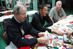 St. Michael the Archangel parishioners Phil Price, from left, his son, William, and Jim Cowden, all of Indianapolis, reminisce about Catholic Scouting during a meeting on Oct. 1 at St. Michael School in Indianapolis. Current and former members of St. Michael Parish’s Boy Scout Troop #400 will celebrate 50 years of continuous Scouting on Nov. 7. (Photo by Mary Ann Wyand) 