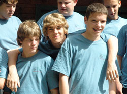 Troy Kunkel, center, puts his arms around James Hood, left, and Liam Mitchel on June 17 during Bishop Bruté Days at the Future Farmers of America Leadership Center in southern Johnson County. Troy is a member of St. Mary Parish in Greensburg. James is a member of St. Malachy Parish in Brownsburg. Liam is a member of St. Joseph Parish in Shelbyville. (Photo by Sean Gallagher)