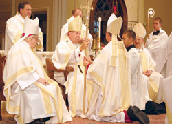 Newly ordained Bishop Timothy L. Doherty of Lafayette receives his crosier from Archbishop Daniel M. Buechlein of Indianapolis during the July 15 episcopal ordination and installation liturgy at the Cathedral of St. Mary of the Immaculate Conception in Lafayette, Ind. (Photo by Caroline Mooney/The Catholic Moment)