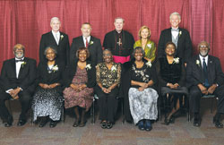 An archdiocesan celebration of Catholic education on Nov. 3 honored four individuals and one family whose Catholic values mark their lives. Standing, from left, are honoree James Schellinger, honoree Dr. Michael Welsh, Archbishop Daniel M. Buechlein, honoree Shirley Yancey Kloepfer and honoree William Kuntz. Sitting, from left, are honored members of the family of Archie and Bettie Smith—Joseph, Sister Demetria (a member of the Missionary Sisters of Our Lady of Africa), Bernadette, Carrie, Doris, Nellie and Holy Cross Brother Roy Smith. (Photo by Rob Banayote)