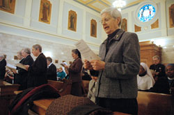 Franciscan Sister Marilyn Hofer, right, and several other members of religious orders ministering across the archdiocese renew their vows during the annual World Day for Consecrated Life Mass celebrated on Jan. 30 at the Blessed Sacrament Chapel of SS. Peter and Paul Cathedral in Indianapolis. Sister Marilyn was honored during the Mass for 60 years of religious life. (Photos by Sean Gallagher)