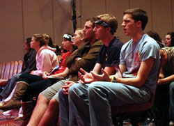 Levi Thompson, from right, Ethan Choates and Jakob Ihli, all of Lake Charles, La., offer praise through music during the National Catholic Collegiate Conference general session on Nov. 19. Young adults from across the country gathered in downtown Indianapolis for the inaugural conference. (Photo by Alea Bowling)