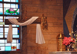 The tabernacle and large, rough-hewn bark cross at St. Ann Church in Terre Haute are among the liturgical furnishings and other items donated by the parish to the archdiocesan seminary, local churches and St. Luke Parish in Salyersville, Ky., whose church was destroyed by a tornado on March 2. St. Ann Parish was closed by the archdiocese on May 20 as part of the Terre Haute Deanery future parish staffing plan. (Photo by Mary Ann Garber)