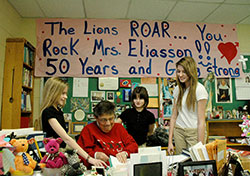 In her 50th year of teaching, Carmen Eliasson shares a fun teaching moment with three of her students at St. Mark School in Indianapolis—Maddie Man, left, Taylor Allen and Megan Pearsey. (Photo by John Shaughnessy)