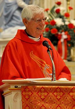 Retired Father John Geis preaches a homily on June 8 at St. John the Evangelist Church in Enochsburg during the Mass of Thanksgiving of Father Daniel Bedel, who had been ordained a priest the previous day. Father Geis, ordained a priest 50 years ago, and Father Bedel both grew up in the former St. John the Evangelist Parish in Enochsburg. (Photo by Sean Gallagher)