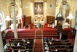 Archbishop Joseph W. Tobin delivers a homily to members of an archdiocesan pilgrimage during Mass at the Basilica of St. Francis Xavier—often called the “Old Cathedral”—in Vincennes, Ind., in the Evansville Diocese, on Sept. 22. An 1870 painted canvas depicts the crucifixion behind the high altar—built in 1904—in the nearly 200-year-old church that served what would later become the Archdiocese of Indianapolis. (Photo by Natalie Hoefer)