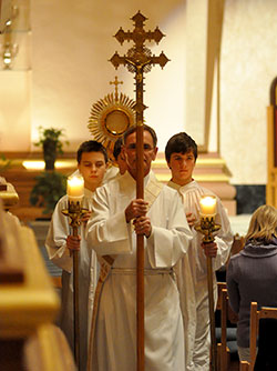 Deacon Michael Braun, director of the archdiocesan Secretariat of Pastoral Ministries, leads a eucharistic procession during the Vigil for Life at SS. Peter and Paul Cathedral in Indianapolis on Jan. 21. Archbishop Joseph W. Tobin carries the Blessed Sacrament at the back of the procession. (Photo by Natalie Hoefer)