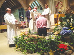 Father Dennis Duvelius, pastor of St. Mark and St. Paul parishes in Tell City, baptizes Ethan Maffia during the Easter Vigil Mass at St. Paul Church on April 15. (Submitted photo)