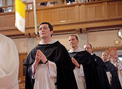 Dominican Brother James Pierce Cavanaugh, left, processes in to St. Vincent Ferrer Church in Chicago on June 2 to profess solemn vows as a member of the Order of Preachers, also known as the Dominicans. (Submitted photo)