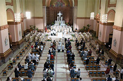 Archbishop Charles C. Thompson processes on March 30, Tuesday of Holy Week, into SS. Peter and Paul Cathedral in Indianapolis at the start of the annual archdiocesan chrism Mass. (Photo by Sean Gallagher)