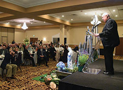 Msgr. Joseph Schaedel, right, speaks on Oct. 18 to attendees of the annual Catholic Radio Indy fundraising dinner after receiving the radio apostolate’s Archbishop Fulton J. Sheen Evangelist of the Year Award. (Photo by Sean Gallagher)