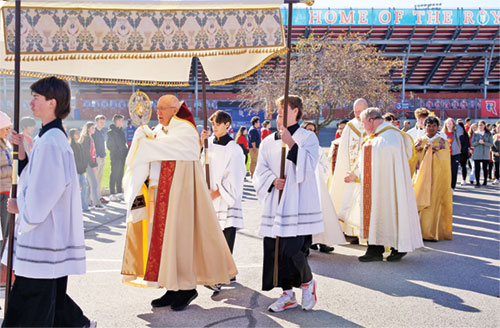 Father Stephen Giannini, pastor of SS. Francis and Clare of Assisi Parish in Greenwood and St. Martin of Tours Parish in Martinsville, carries a monstrance on Nov. 3, 2023, during a eucharistic procession at Roncalli High School in Indianapolis. (Submitted photo)