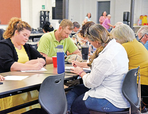 Catholics from across southeastern Indiana fill out questionnaires related to the archdiocesan pastoral planning process during an Aug. 24 listening session at St. Louis Parish in Batesville. (Photo by Sean Gallagher)