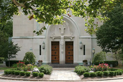 There are now 50 adopted flower beds on the grounds of St. Mary Parish, cared for by dozens of volunteers. The parish’s garden ministry began in 2007. At left: Garden 4 in front of the church is cared for by Sherry and David Stagge and their children. (August 2009 photo by Louisa J. Reese)